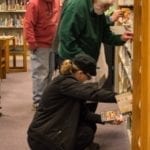 library patrons browsing bookshelf
