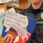 police officer holding children's books