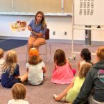 Adult reading story to children