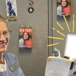 Librarian reading book with light therapy lamp