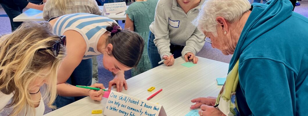 People writing words on colored paper.