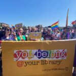 Library staff hold parade banner that reads You Belong at Your Library