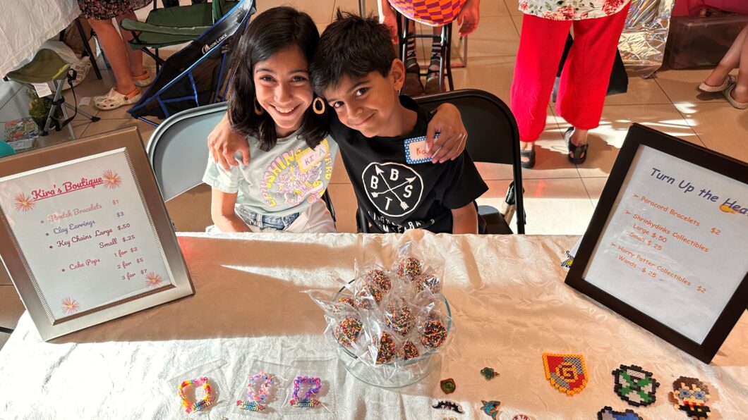 Two children selling craft fair items