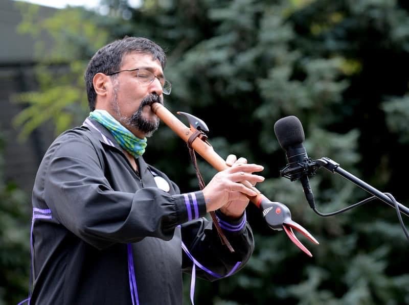 Peter Ali playing a flute