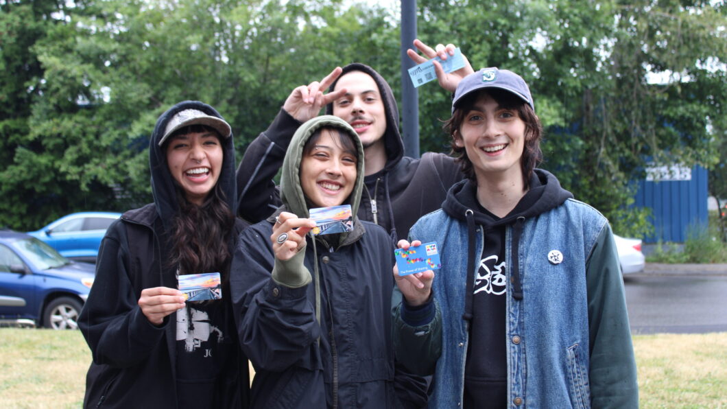 Group of young people holding library cards