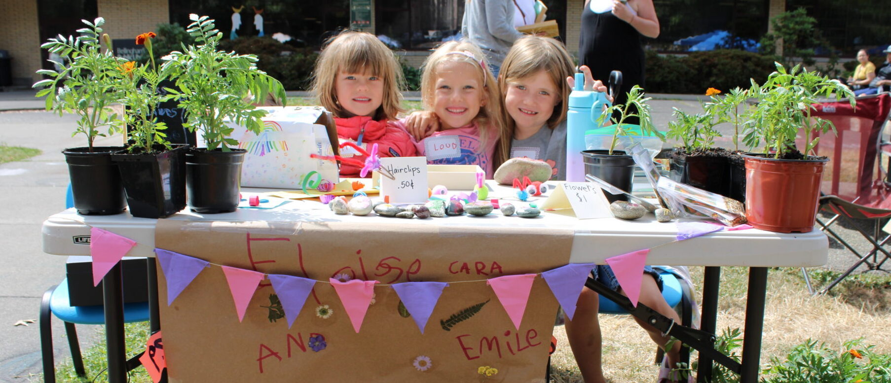 Three children selling treasures at the Craft Fair