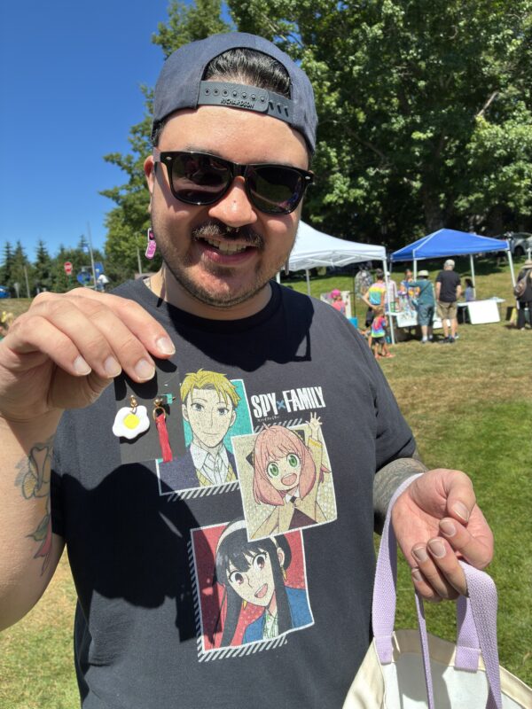library staff member holding up a pair of earrings