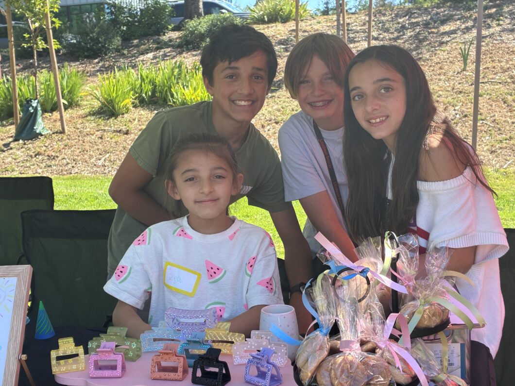 Four children selling their handmade items