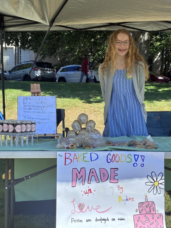 Child selling baked goods at the Craft Fair