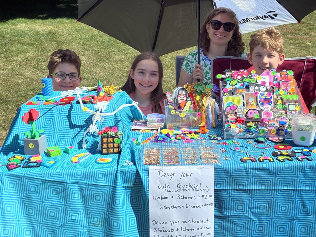 A group of children selling colorful beaded creations