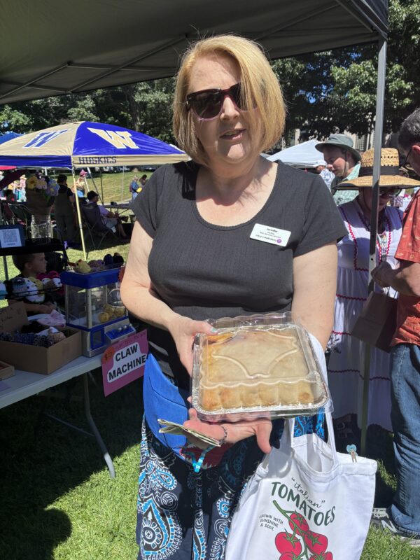 Woman holding up a tray of homemade bread