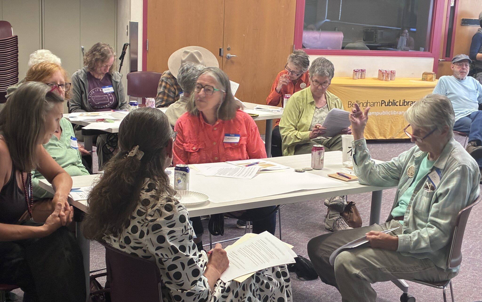 Group of adults in discuss topics at Library program.